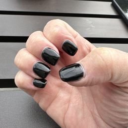Hand with black gel nails. Hand with black gel nails.