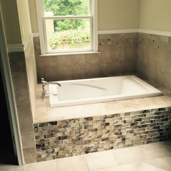 Thinking Of Granite - a bathtub and window in a bathroom - Cabinetry Near Me Thinking Of Granite - a bathtub and window in a bathroom - Cabinetry Near Me