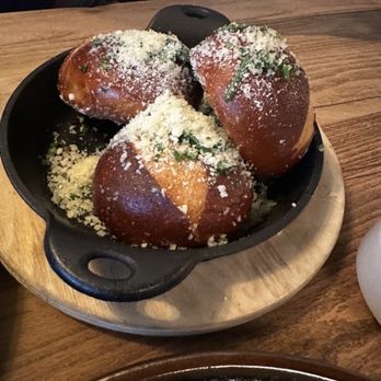 Junior Restaurant - Pretzel rolls topped with Parmesan cheese, served with a side of truffle aioli - Lounges Near Me - Roseville, California Junior Restaurant - Pretzel rolls topped with Parmesan cheese, served with a side of truffle aioli - Lounges Near Me - Roseville, California