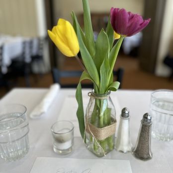 Simon's Restaurant - a table setting with flowers in a vase - American Near Me - Midway, Utah