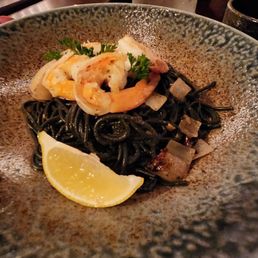 Seafood squid ink pasta with loads of sautéed garlic and onions