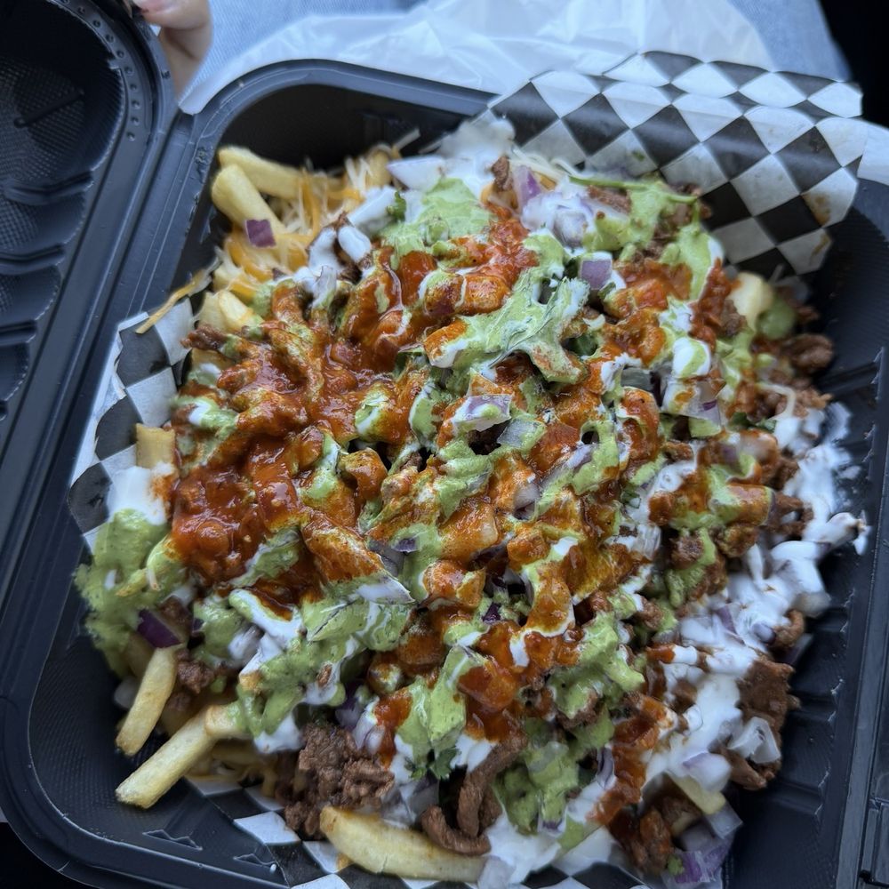 Asada fries with everything on them Asada fries with everything on them