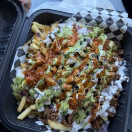 Asada fries with everything on them Asada fries with everything on them