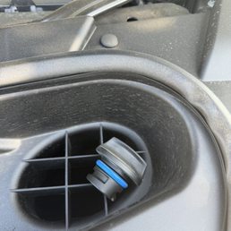 Oil cap sitting on top of grille Oil cap sitting on top of grille