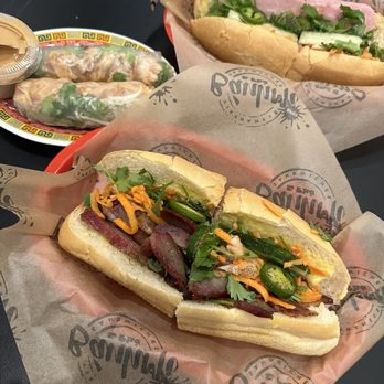 Banh Mi Spot - BBQ pork banh mi (bottom), classic banh mi, chicken spring rolls - Vietnamese Near Me - Chicago, Illinois Banh Mi Spot - BBQ pork banh mi (bottom), classic banh mi, chicken spring rolls - Vietnamese Near Me - Chicago, Illinois