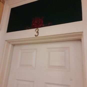 Grand Canyon International Hostel - The glass above the doors have been painted and roses have been painted in different stages of blooming - Hotels Near Me - Flagstaff, Arizona