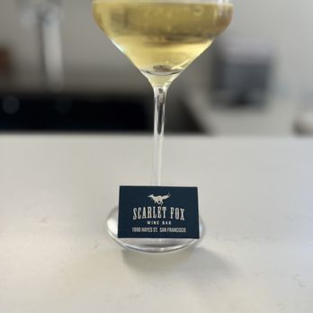 Scarlet Fox - Glass of white wine with a book of matches branded with the Scarlet Fox logo - Wine Bars Near Me - San Francisco, California Scarlet Fox - Glass of white wine with a book of matches branded with the Scarlet Fox logo - Wine Bars Near Me - San Francisco, California