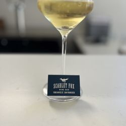 Scarlet Fox - Glass of white wine with a book of matches branded with the Scarlet Fox logo