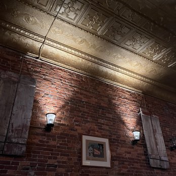 AV - a brick wall with two lamps and a picture on the wall - Bars Near Me - Scranton, Pennsylvania