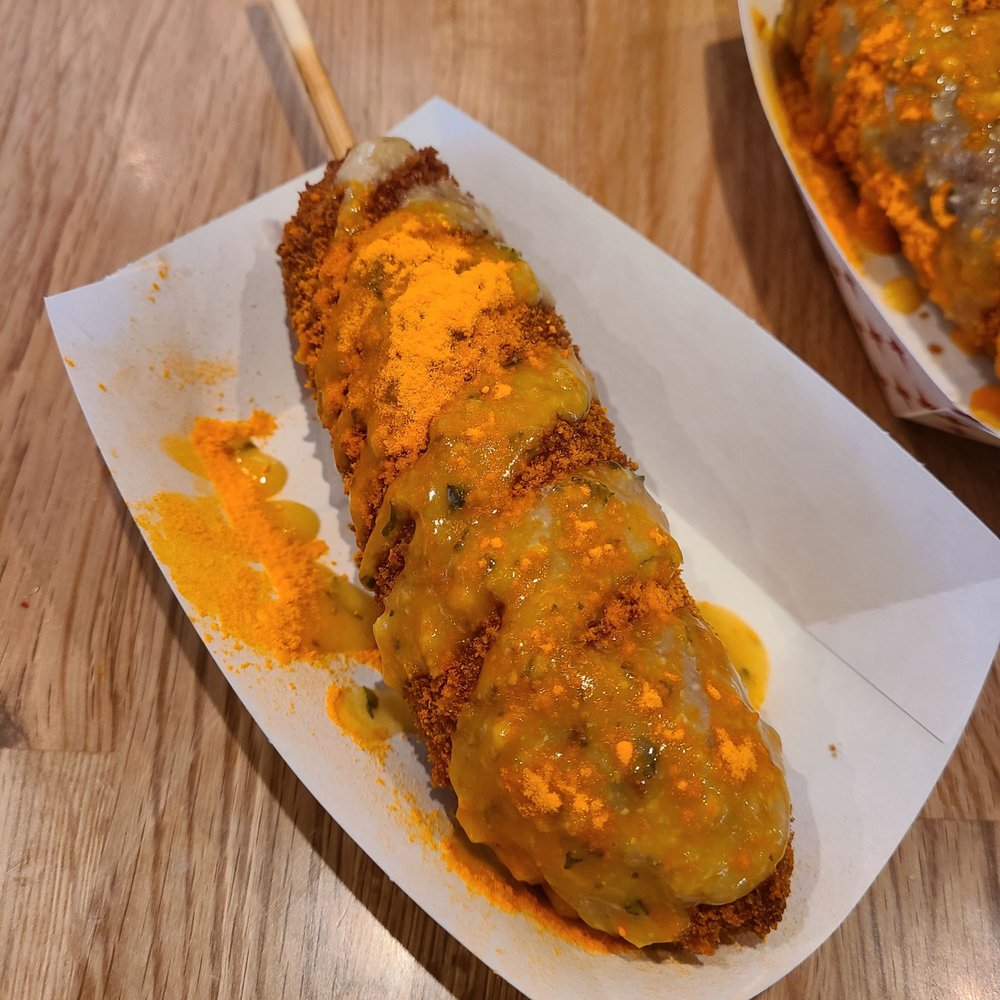 CrunCheese - a hot dog covered in cheese and mustard - Hot Dogs Near Me - Minneapolis, Minnesota CrunCheese - a hot dog covered in cheese and mustard - Hot Dogs Near Me - Minneapolis, Minnesota