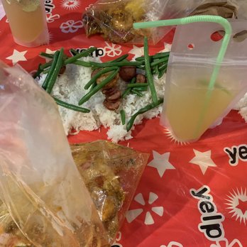 The Crab Pad - My juice box, the rice and sausage on the table, bag of seafood - Seafood Near Me - Chicago, Illinois