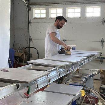 Bowzer Broz Painting - Jake sanding the kitchen cabinets. He primed and painted them and expertly hung them. - Painters Near Me Bowzer Broz Painting - Jake sanding the kitchen cabinets. He primed and painted them and expertly hung them. - Painters Near Me