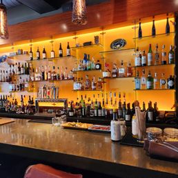 a bar with many bottles of alcohol a bar with many bottles of alcohol