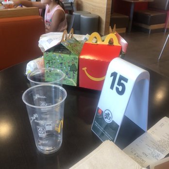 McDonald's - a little girl sitting at a table in a fast food restaurant - Fast Food Near Me - Manor, Texas