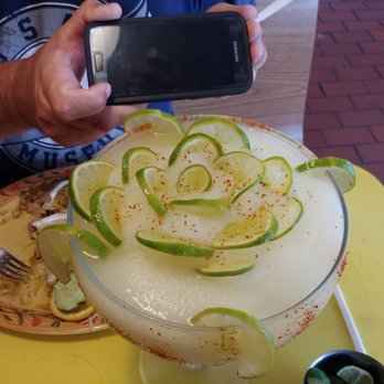 Los Compadres Mexican Restaurant - This margarita is like art! Cell phone for perspective! HUGE!!! - Mexican Near Me - Kenosha, Wisconsin