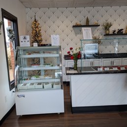 a bakery counter with a glass case a bakery counter with a glass case