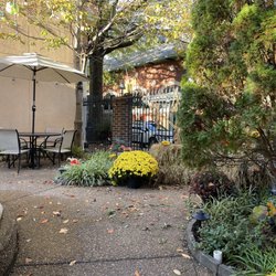 Mi Lindo Michoacán Mexican Restaurant - Tables and fall decorations in the quaint courtyard next to the sidewalk.