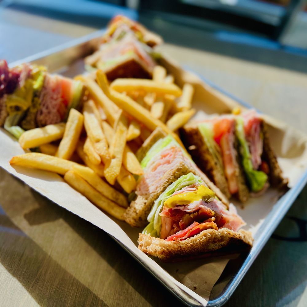 Lighthouse Cafe - Club Sandwich w/ Ham, Bacon, Turkey, Mustard, Lettuce, Tomato on toasted wheat, fries on the side - Breakfast & Brunch Near Me - San Pedro, California Lighthouse Cafe - Club Sandwich w/ Ham, Bacon, Turkey, Mustard, Lettuce, Tomato on toasted wheat, fries on the side - Breakfast & Brunch Near Me - San Pedro, California
