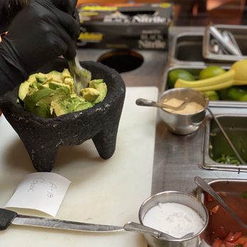 Salsa's Mexican Grill - a person preparing a salad - Mexican Near Me - Mishawaka, Indiana Salsa's Mexican Grill - a person preparing a salad - Mexican Near Me - Mishawaka, Indiana