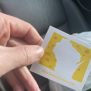 The Cheese Haus - a person holding a piece of cheese - Cheese Shops Near Me - Colorado Springs, Colorado The Cheese Haus - a person holding a piece of cheese - Cheese Shops Near Me - Colorado Springs, Colorado