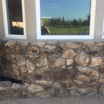 Jones Masonry - What was a bashed in, leaky wall, was rebuilt using the old rocks. Greg's crew very carefully salvaged and cleaned each rock. - General Contractors Near Me
