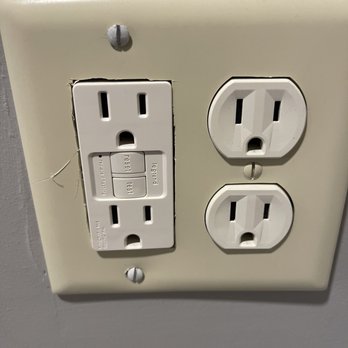 Mathis Roofing - Seriously? This is was done instead of spending $5 for a outlet cover that wasn't made with a dremel tool - General Contractors Near Me - Brevard, North Carolina