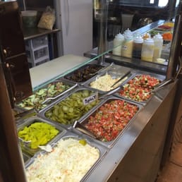 a variety of salads and condiments a variety of salads and condiments