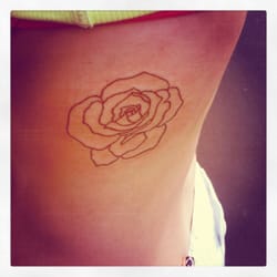 Physical Graffiti Tattoo Studio - Rib tat: Outline of a rose by Gooch. Love it blank. Not filling it in.