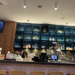 UMI Sushi & Lounge - Bar with dishes all over it
