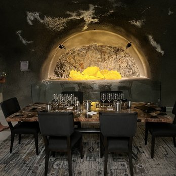 Pine Ridge Vineyards - a wine cellar with a table and chairs - Wineries Near Me - Napa, California Pine Ridge Vineyards - a wine cellar with a table and chairs - Wineries Near Me - Napa, California