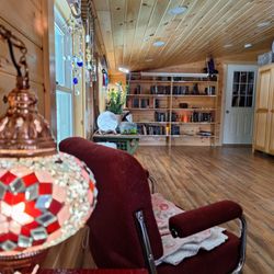 Solstice - long view of our new room. books, ritual supplies, and quite a bit more that that.