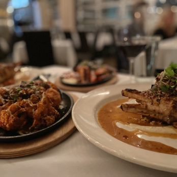 Queenie's Steakhouse - Buffalo Cauliflower (so good!) and pork chop - Steakhouses Near Me - Denton, Texas