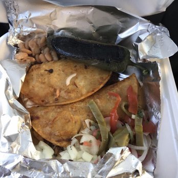 Pobres Tacos - Two soggy Birria tacos with some beans, a huge jalapeño pepper and other onions and peppers. - Tacos Near Me - Los Angeles, California