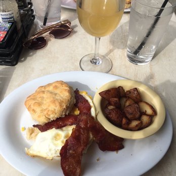 Ruby Slipper Baton Rouge - Bam Bam Biscuit with breakfast potatoes and a peach bellini. - Cafes Near Me - Baton Rouge, Louisiana Ruby Slipper Baton Rouge - Bam Bam Biscuit with breakfast potatoes and a peach bellini. - Cafes Near Me - Baton Rouge, Louisiana
