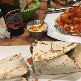 Not the prettiest picture (we hadn't eaten all day, started eating ‍! Durum Kebab, Chicken Burger, Patatas Bravas w/aioli.