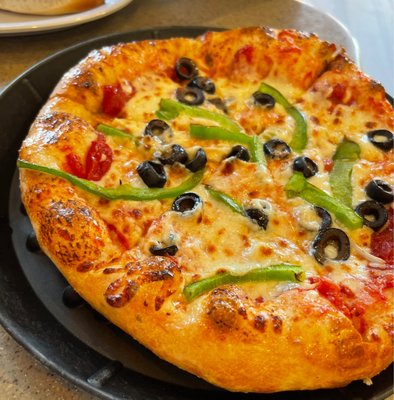 Photo of Greek’s Pizza - Martinsville, IN, US. a pizza with olives and peppers