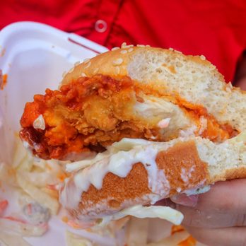 Thyme Traveling - a person holding a sandwich in a styrofoam container - Food Trucks Near Me