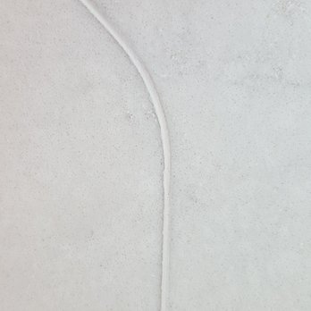 Rumford Stone - Showroom - large seam with bright white caulk, no blending - Kitchen & Bath Near Me - Pembroke, New Hampshire