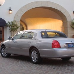 Express RDU Taxi & Towncar - Company car parked outside a business waiting for client pick-up.