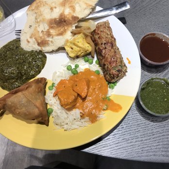 Noon Mirch - from top clockwise: naan, Chicken Malai Kebab, Seekh Kebab, tikka masala atop basmati rice, samosa, Saag Paneer, and Death Wings on the side - Indian Near Me - Webster, Texas Noon Mirch - from top clockwise: naan, Chicken Malai Kebab, Seekh Kebab, tikka masala atop basmati rice, samosa, Saag Paneer, and Death Wings on the side - Indian Near Me - Webster, Texas