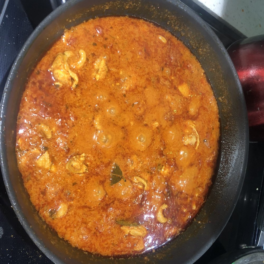 Butter Chicken - a skillet on a stove top - Indian Near Me - Toronto, Ontario Butter Chicken - a skillet on a stove top - Indian Near Me - Toronto, Ontario
