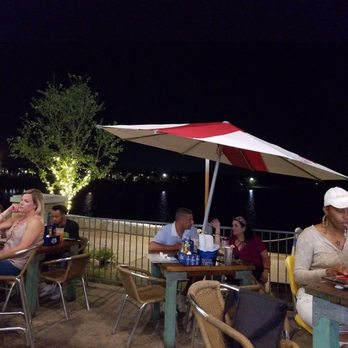 Sam's Boat - Outside bar on the patio at night. - Sports Bars Near Me - Cypress, Texas
