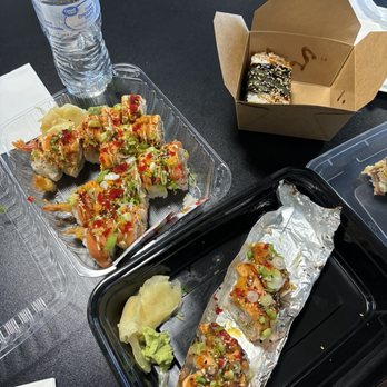 Oishi Express - Tiger roll (top left) yum yum roll (middle) Lion king (one with foil bottom) spam masubi (in box) - Sushi Bars Near Me - Elk Grove, California Oishi Express - Tiger roll (top left) yum yum roll (middle) Lion king (one with foil bottom) spam masubi (in box) - Sushi Bars Near Me - Elk Grove, California