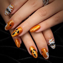 Pure Nails Spa - Golden glow with a spooky little twist. Playful Halloween details, polished to perfection at Pure Nails Spa.