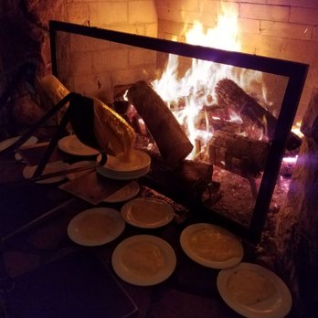 Fireside Dining - Food porn. Raclette dripping onto plates by the fire. - French Near Me - Park City, Utah Fireside Dining - Food porn. Raclette dripping onto plates by the fire. - French Near Me - Park City, Utah