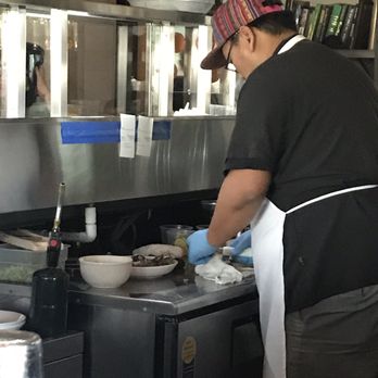 The Gladly - Working on our oysters shucking them - New American Near Me - Phoenix, Arizona