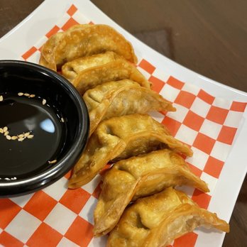 Wild Ginger Teriyaki - a plate of dumplings and a bowl of dipping sauce - Japanese Near Me - Renton, Washington Wild Ginger Teriyaki - a plate of dumplings and a bowl of dipping sauce - Japanese Near Me - Renton, Washington