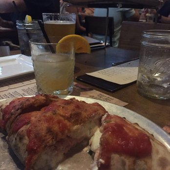 Cinder Bar - Prosciutto cotto and mushroom calzone with the white tropical sangria in the back. - Bars Near Me - Clarksboro, New Jersey Cinder Bar - Prosciutto cotto and mushroom calzone with the white tropical sangria in the back. - Bars Near Me - Clarksboro, New Jersey