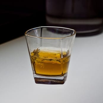 Living Room Bar - a glass of whiskey on a table - Lounges Near Me - Hoboken, New Jersey Living Room Bar - a glass of whiskey on a table - Lounges Near Me - Hoboken, New Jersey