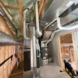 Gold Star Heating and Air - An HVAC system, including furnaces and extensive ductwork, is being installed in an unfinished space with exposed wooden fram...
